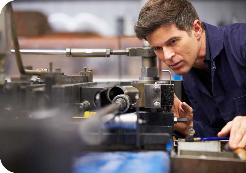 Technician inspecting machinery